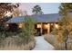 Charming home featuring a covered front porch, landscaped yard, and inviting walkway at 1800 S Niagara Way, Denver, CO 80224