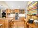 Beautiful kitchen featuring wooden cabinets, stainless steel appliances, and an island with granite countertops at 1800 S Niagara Way, Denver, CO 80224