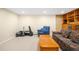 Cozy living room featuring a comfortable couch, a side chair, and built-in shelving at 1800 S Niagara Way, Denver, CO 80224