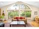 The living room includes a large arched window, sliding doors to deck, and is flooded with natural light at 1800 S Niagara Way, Denver, CO 80224