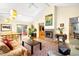 Spacious living room with a fireplace, hardwood floors, large picture window, and comfortable seating area at 1800 S Niagara Way, Denver, CO 80224