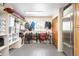 Organized mudroom featuring built-in shelving, storage, a door, a window and stainless steel refrigerator at 1800 S Niagara Way, Denver, CO 80224