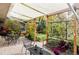 Relaxing brick patio area with comfortable seating, a pergola, and lush greenery at 1800 S Niagara Way, Denver, CO 80224
