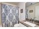 Bathroom with patterned shower curtain, sink, granite countertop and vanity at 10554 Tracewood Cir, Highlands Ranch, CO 80130