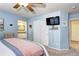 Bedroom featuring closet, mounted TV, neutral carpet, and view to the ensuite bath at 10554 Tracewood Cir, Highlands Ranch, CO 80130