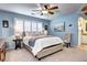 Bedroom with blue walls, fan, a plush bed and a chair at 10554 Tracewood Cir, Highlands Ranch, CO 80130