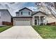 Charming two-story home featuring a brick garage and a welcoming front porch with stylish columns at 10554 Tracewood Cir, Highlands Ranch, CO 80130
