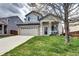 Charming home featuring a well-manicured lawn, brick accents, and a two-car garage at 10554 Tracewood Cir, Highlands Ranch, CO 80130