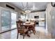 Bright kitchen with a view to outdoor seating featuring a wooden dining table and white cabinets at 10554 Tracewood Cir, Highlands Ranch, CO 80130