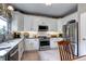 Bright kitchen featuring white cabinets, granite countertops, stainless steel appliances, and tiled floor at 10554 Tracewood Cir, Highlands Ranch, CO 80130