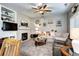 Cozy living room featuring a fireplace, built-in shelving, and plush seating with ample natural light at 10554 Tracewood Cir, Highlands Ranch, CO 80130