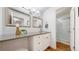 This bathroom features a large countertop, a sink and vanity, and a shower with glass doors at 10185 W 25Th Ave # 31, Lakewood, CO 80215