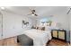 This bedroom features wood floors, a ceiling fan, and large windows at 10185 W 25Th Ave # 31, Lakewood, CO 80215
