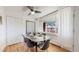 Dining area with a modern glass table, stylish chairs, and a view of outdoor scenery, creating an inviting space at 10185 W 25Th Ave # 31, Lakewood, CO 80215