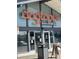 A commercial property with the sign 'dogtopia daycare + overnight + spa' and entrance with glass doors at 10185 W 25Th Ave # 31, Lakewood, CO 80215