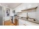 Modern kitchen featuring stainless steel appliances, white subway tile backsplash, and wood flooring for a sleek design at 10185 W 25Th Ave # 31, Lakewood, CO 80215