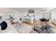 Cozy living room featuring modern furniture, sleek bar seating, and a mounted TV for comfortable and stylish living at 10185 W 25Th Ave # 31, Lakewood, CO 80215