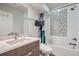 Modern bathroom with stylish herringbone tile shower and sleek vanity at 1439 Garfield St, Denver, CO 80206