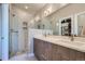 Modern bathroom with a double vanity, glass-enclosed shower, and designer fixtures at 1439 Garfield St, Denver, CO 80206