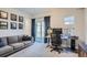 Comfortable home office featuring a gray sofa and desk with sliding glass door at 1439 Garfield St, Denver, CO 80206