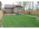 Spacious backyard with a wooden deck, a well-maintained lawn, and a privacy fence at 1395 S Josephine St, Denver, CO 80210
