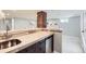 Basement bar area featuring a sink, mini fridge, and a view of seating area at 1395 S Josephine St, Denver, CO 80210