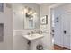 Updated bathroom featuring a pedestal sink, tiled shower, and modern fixtures at 1395 S Josephine St, Denver, CO 80210