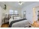 Bright bedroom featuring a plush bed, ceiling fan, and neutral decor at 1395 S Josephine St, Denver, CO 80210