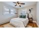 Cozy bedroom with wood floors, bright windows, and a ceiling fan at 1395 S Josephine St, Denver, CO 80210