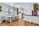 Open dining room with a breakfast bar, a large window, and hardwood floors at 1395 S Josephine St, Denver, CO 80210
