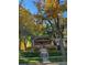 Charming brick home with a lovely front porch and beautiful landscaping, surrounded by mature trees at 1395 S Josephine St, Denver, CO 80210