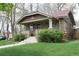 Charming brick home with a tiled roof, cozy front porch, and well-maintained lawn at 1395 S Josephine St, Denver, CO 80210