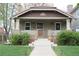 Charming brick home with a beautiful tiled roof and a manicured front yard at 1395 S Josephine St, Denver, CO 80210