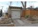 Detached garage with a tile roof and brick facade complementing the well-manicured landscaping at 1395 S Josephine St, Denver, CO 80210