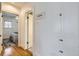 Hallway with storage cabinet leading to a bedroom, showcasing the home's layout at 1395 S Josephine St, Denver, CO 80210