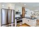 Modern kitchen featuring stainless steel appliances, white cabinets, and hardwood floors at 1395 S Josephine St, Denver, CO 80210