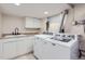 Functional laundry room featuring a sink with ample counter space and modern appliances at 1395 S Josephine St, Denver, CO 80210
