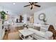 Bright living room with white sofa and hardwood floors at 1395 S Josephine St, Denver, CO 80210