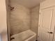Bright bathroom featuring a shower-over-tub and fresh white door at 50 E Highline Cir # 101, Centennial, CO 80122