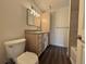 Clean bathroom with wood vanity, granite countertop, and wood look floors at 50 E Highline Cir # 101, Centennial, CO 80122