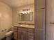 Neutral bathroom with granite counters, sink, and plentiful cabinet storage at 50 E Highline Cir # 101, Centennial, CO 80122