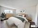 Well-lit bedroom with a queen size bed, matching nightstands, dresser, and a soft rug for added comfort at 50 E Highline Cir # 101, Centennial, CO 80122