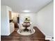 Dining area with a round table, four chairs, modern light fixture, and beautiful hardwood floors at 50 E Highline Cir # 101, Centennial, CO 80122