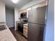 Kitchen featuring stainless steel appliances, granite countertops, ample storage, and a view of the adjacent room at 50 E Highline Cir # 101, Centennial, CO 80122