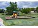 Community playground surrounded by mature trees, providing a safe and fun area for children to play at 50 E Highline Cir # 101, Centennial, CO 80122