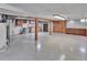 Large unfinished basement with tile floor, wood accents, and utility hookups, offering customizable space at 4960 S Fox St, Englewood, CO 80110