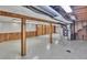 Spacious unfinished basement with tile floor, wood supports, and open utilities, offering customizable potential at 4960 S Fox St, Englewood, CO 80110