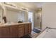 Bathroom with double sinks, shower, and bathtub at 427 S Quay St, Lakewood, CO 80226