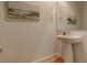 Clean and modern half bathroom with pedestal sink at 427 S Quay St, Lakewood, CO 80226