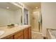 Bathroom with double sinks, shower, and bathtub at 427 S Quay St, Lakewood, CO 80226